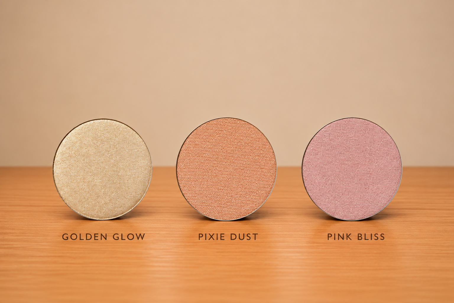 Three round makeup pans in warm shimmer shades